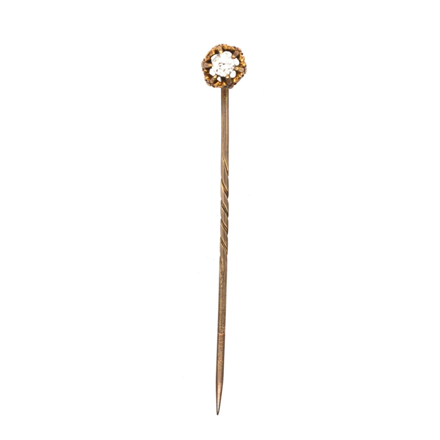 Victorian 15ct gold stickpin featuring a 0.20ct old mine cut diamond with fleur-de-lis motifs, circa 1880.