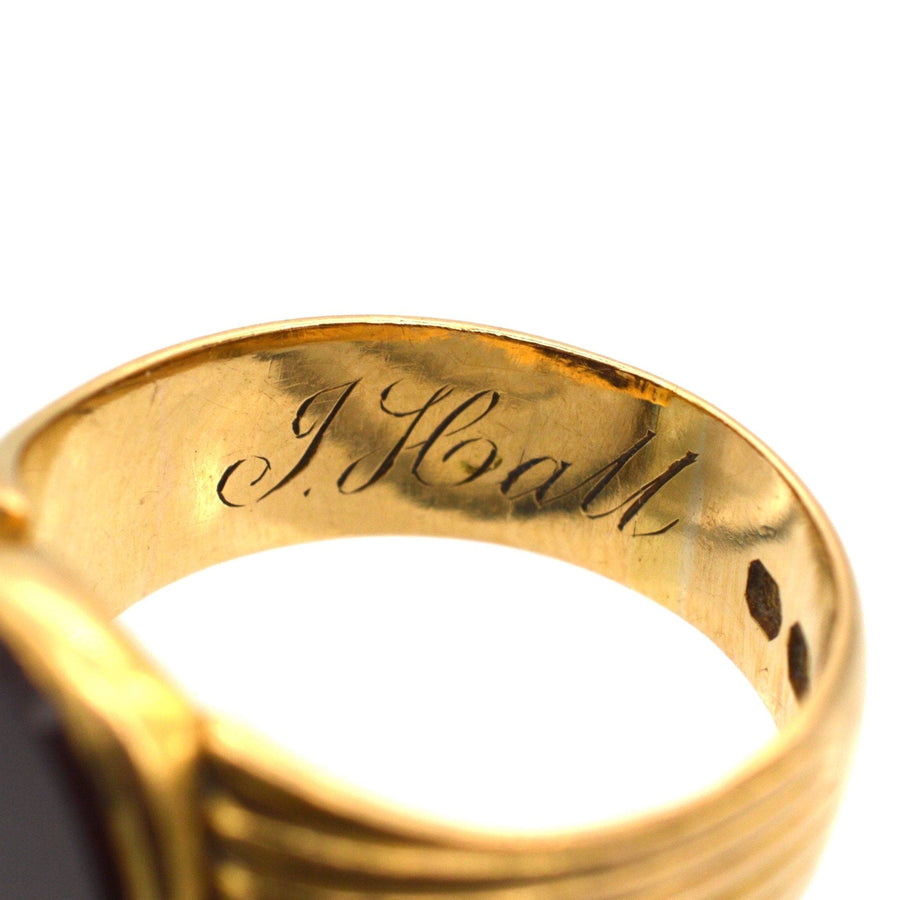 Engraving of 'J. Hall' inside a Victorian 18ct gold signet ring with carnelian stone, showcasing craftsmanship.