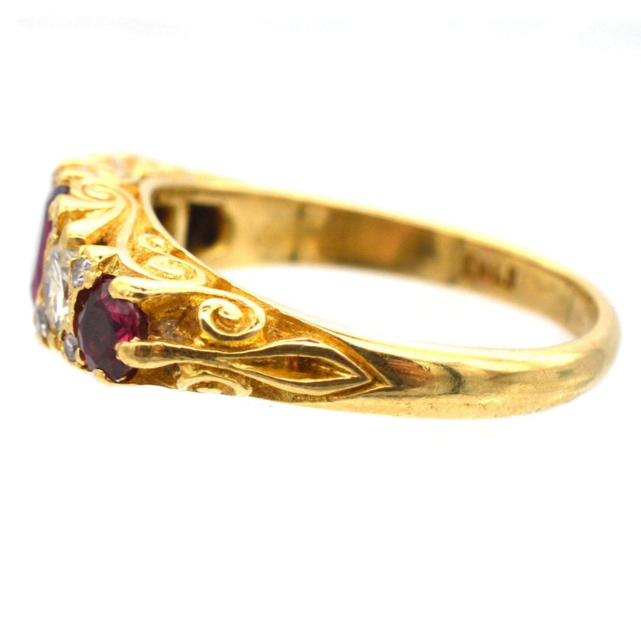 Victorian-style 1970s gold ring with rubies and diamond, featuring intricate carved design.