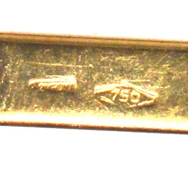 Close-up of gold stamp showing 750 stamp on vintage cufflinks.