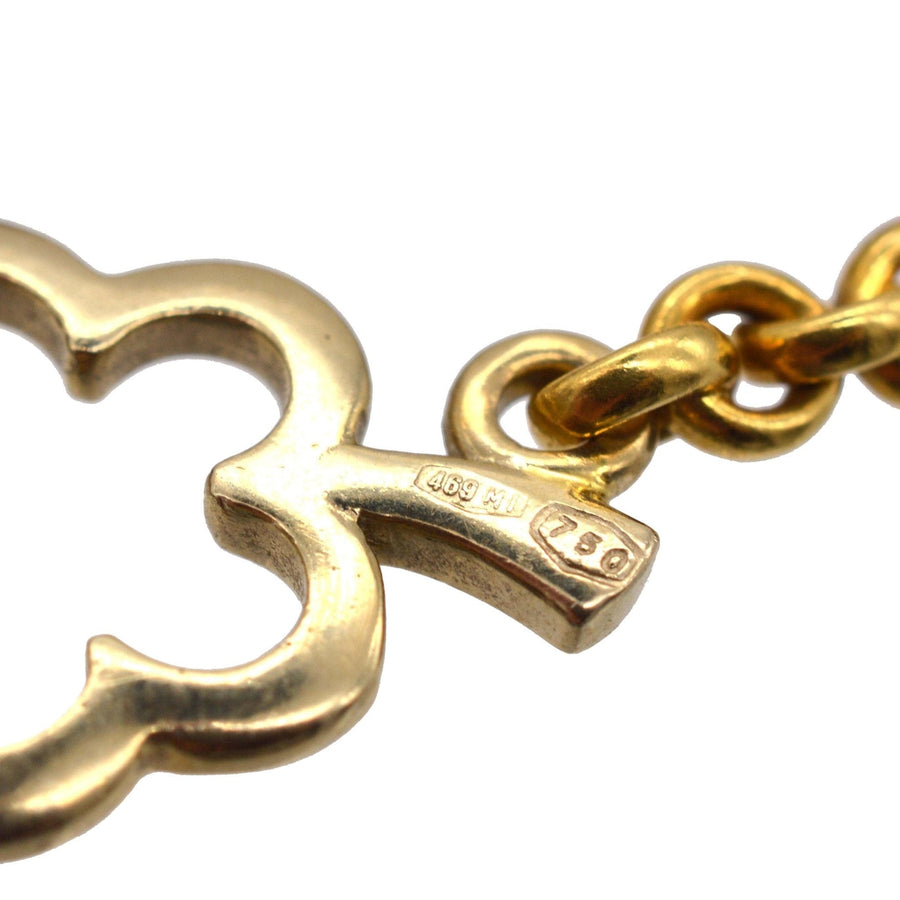 Close-up of a vintage 18ct gold link from Pomellato necklace, showcasing its iconic design and stamp.