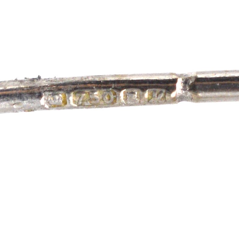 Close-up of a 750 stamp on white gold jewelry, indicating 18ct purity for fine craftsmanship.