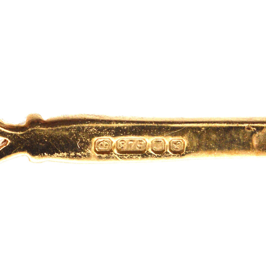 Close-up of the stamp on a vintage 9ct gold brooch, displaying '375' stamp for gold purity.
