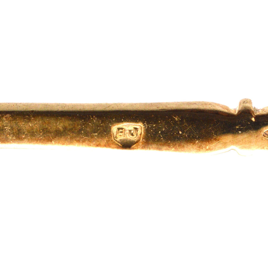 Vintage 9ct gold bar brooch with stamp detail, showcasing exquisite craftsmanship and design.