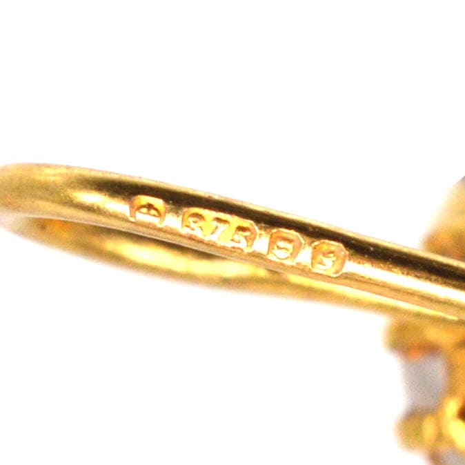 Close-up of the stamp on a vintage 9ct gold earring, showcasing the gold quality and craftsmanship.