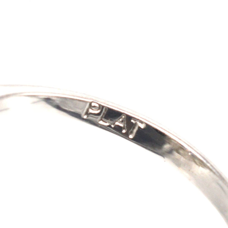 Close-up of a vintage platinum ring showing the 'PLAT' stamp inscription.