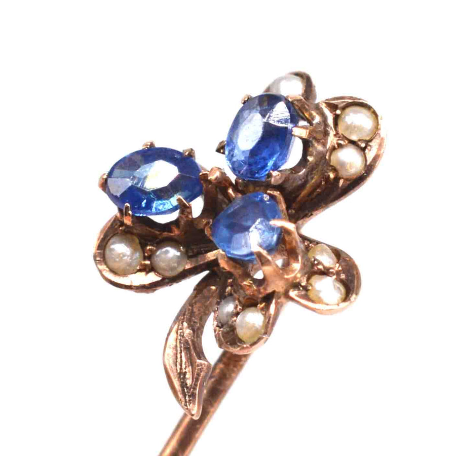 Early 20th century 8ct gold tie pin with sapphire and seed pearl, featuring a clover motif for good luck.