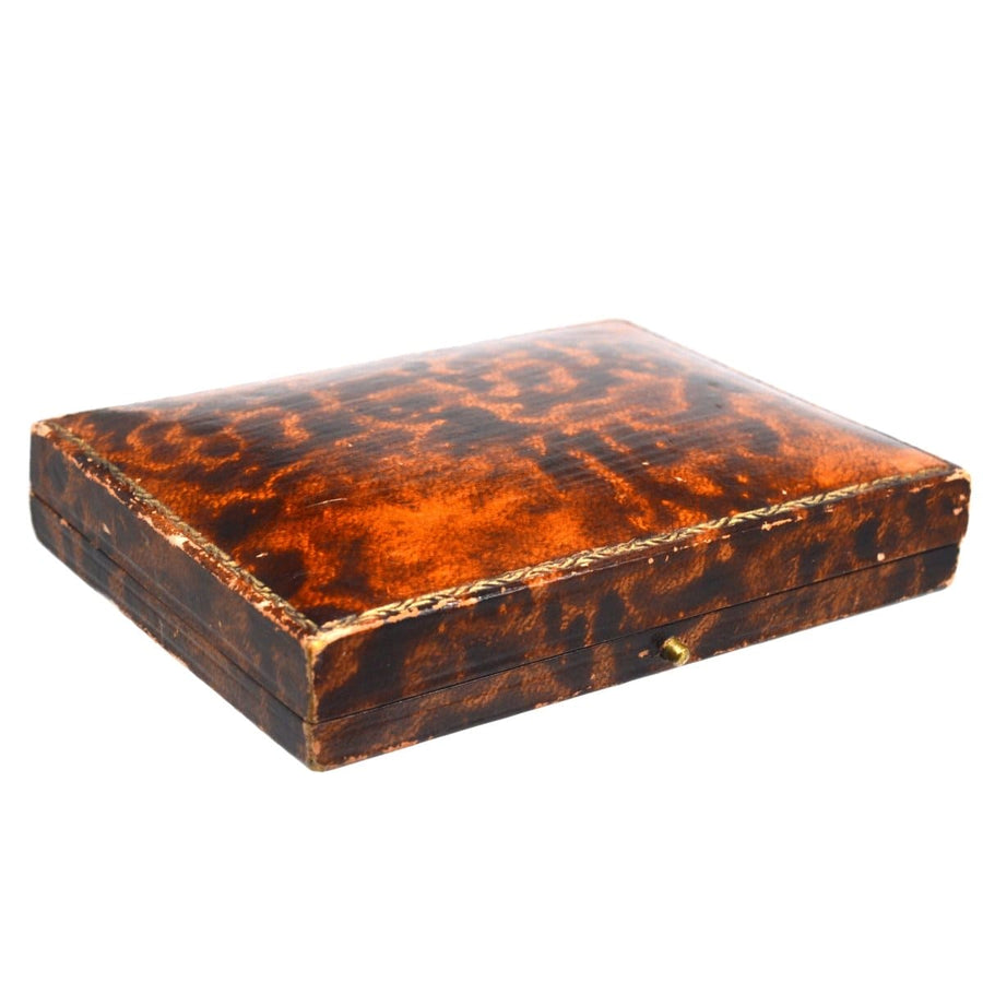 Vintage brown leather box for jewelry, showing intricate textures and a classic design.