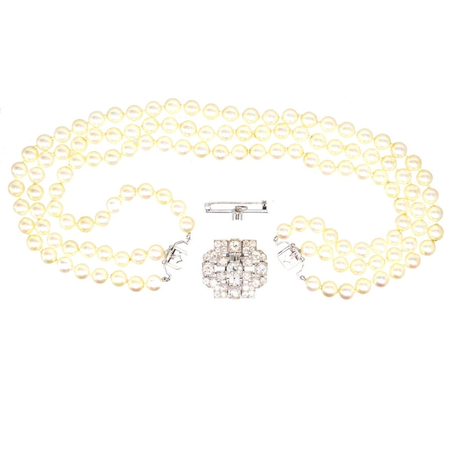 Art Deco platinum diamond brooch with 7 carats of diamonds and pearl necklace attachment in original case.