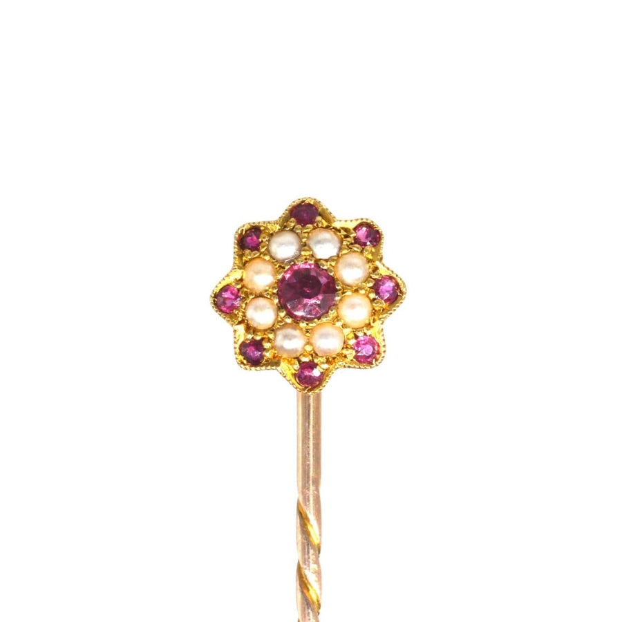 Edwardian gold flower tie pin with garnet and seed pearl cluster, perfect for elegant occasions.