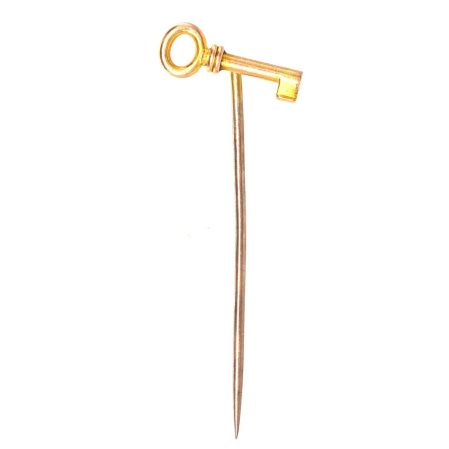 Edwardian 15ct gold tie pin shaped like a key, symbolizing love, new beginnings, and success.