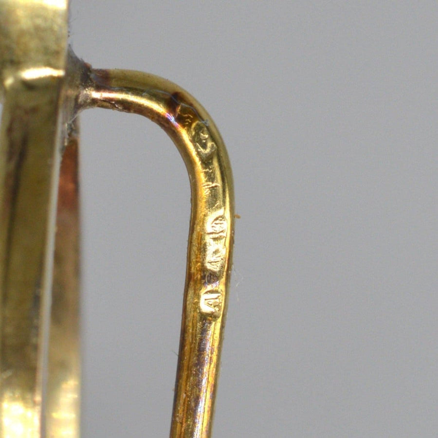 Close-up of the hallmark on a 9ct gold tie pin, showcasing its detailed engraving and quality craftsmanship.