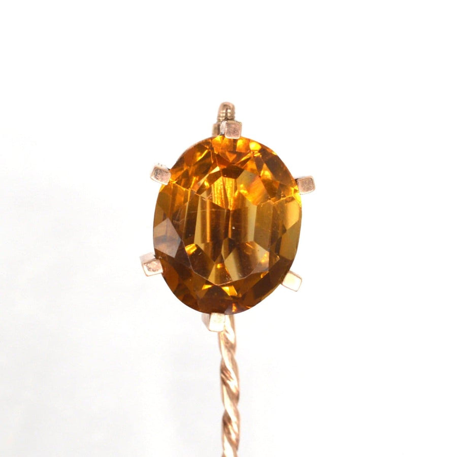 Close-up of a large 9ct gold tie pin featuring a stunning oval citrine stone in a retro claw setting.