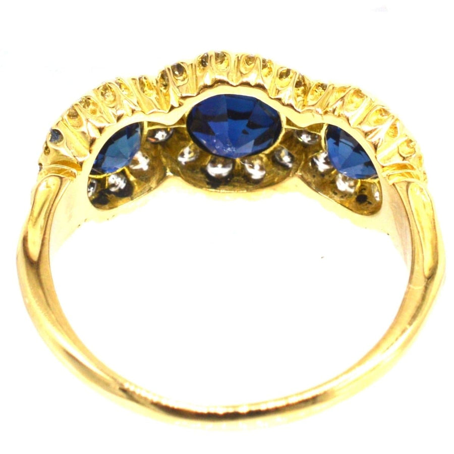 Vintage 18ct gold ring featuring sapphire and diamond clusters, crafted in 1975 in London, elegant engagement option.