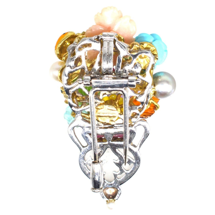 Vintage 18ct white gold brooch by Santagostino featuring multi-gem flowers and a rock crystal vase.