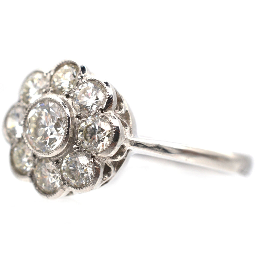 Art Deco platinum diamond cluster ring with a sparkling millegrain setting, perfect for an engagement.