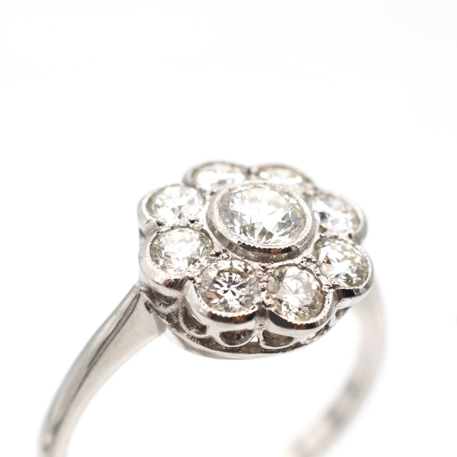 Art Deco platinum diamond cluster ring with a millegrain setting, featuring over a carat of sparkling diamonds.