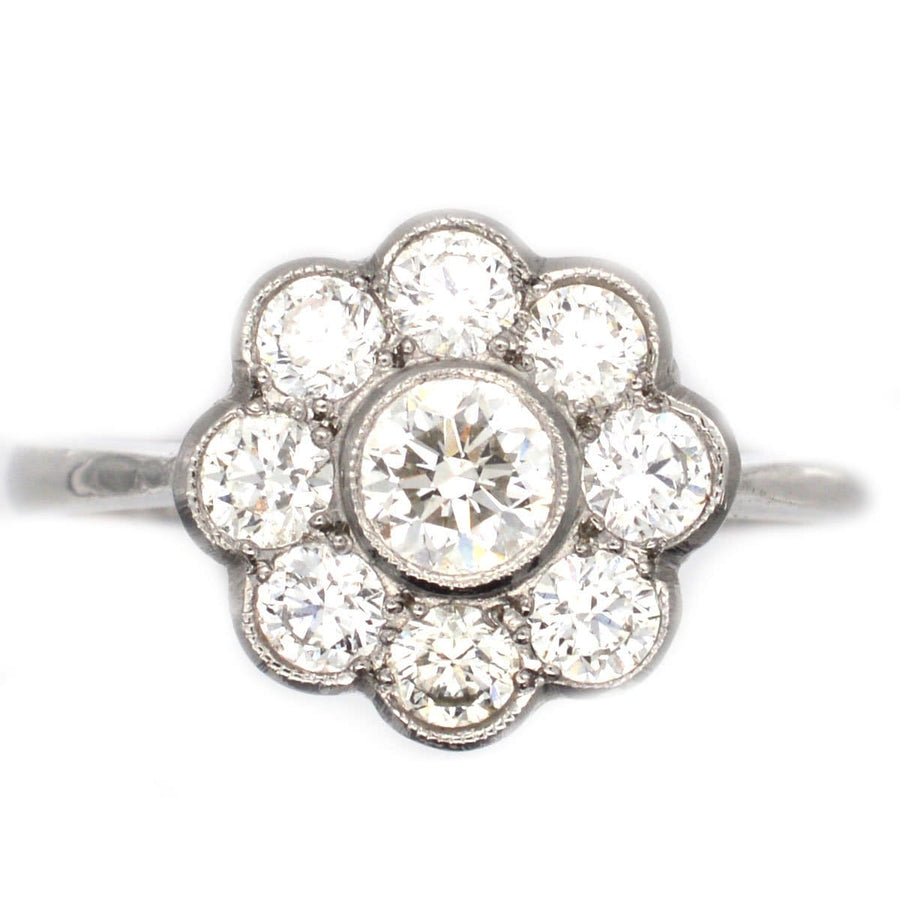 Art Deco platinum diamond cluster ring featuring over a carat of sparkling diamonds in a beautiful millegrain setting.