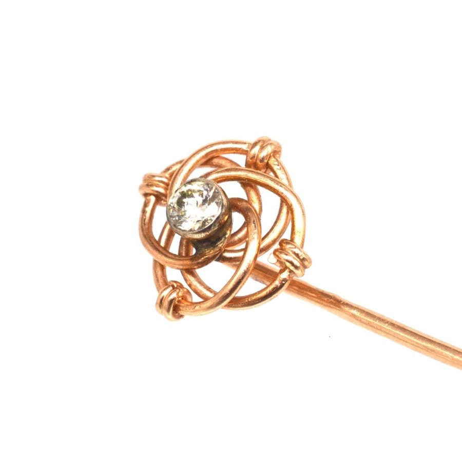 Austro-Hungarian 14ct gold and diamond knot tie pin with an intricate knot design and a sparkling diamond centerpiece.