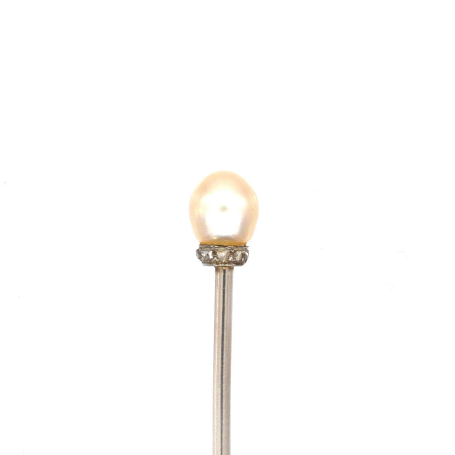 Elegant Edwardian platinum stickpin featuring a lustrous natural pearl and tiny sparkling rose diamonds.