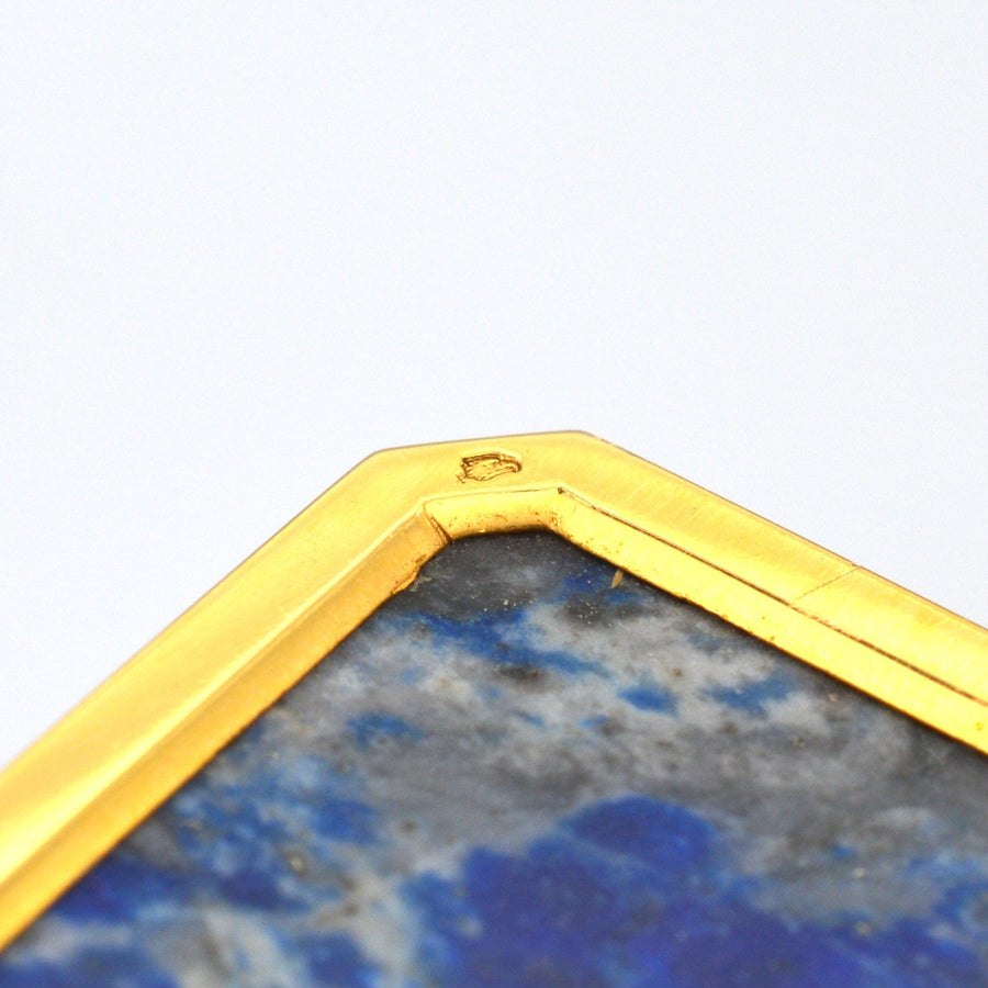 特写青金石钟上的 18K 金镶边，展示工艺和细节。