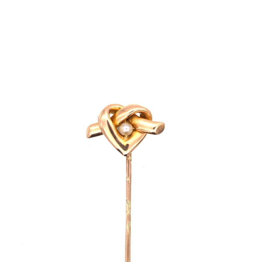 15ct gold lover's knot tie pin in heart motif with natural pearl, dating from 1880-1900.