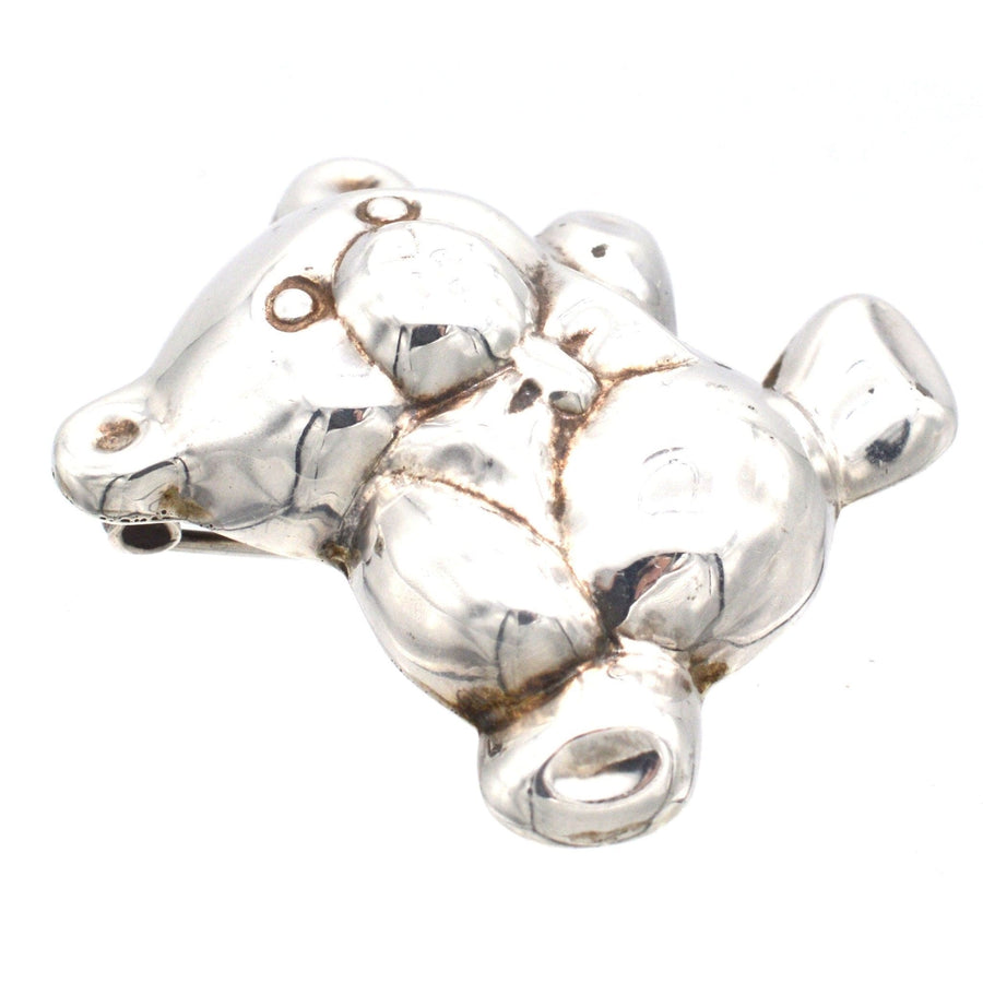Mid-century silver teddy bear brooch pendant with a bow tie, perfect for christening or baby gifts.