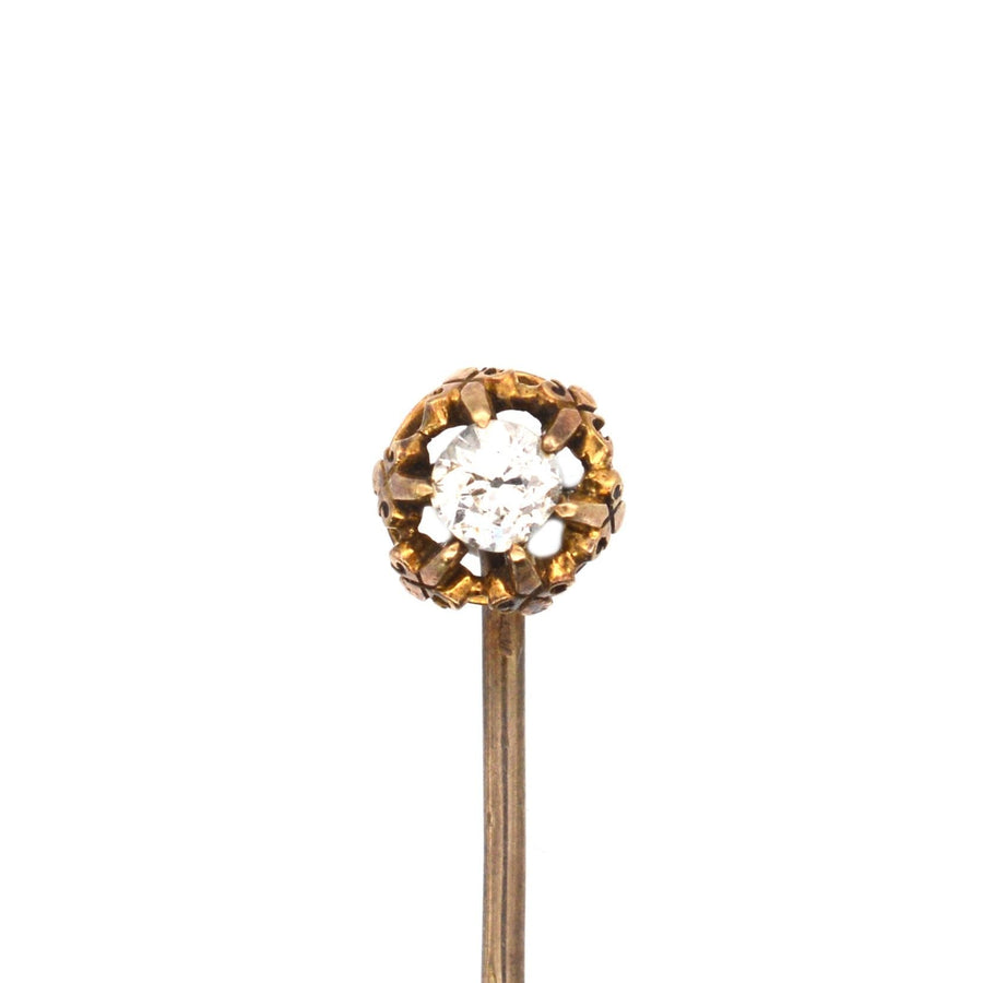 Victorian 15ct gold stickpin featuring a 0.20ct old mine cut diamond with fleur-de-lis motifs, circa 1880.