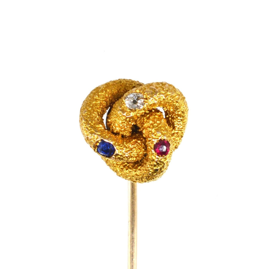 Victorian 15ct gold knot tie pin with sapphire, diamond, and ruby, symbolizing love and strength.
