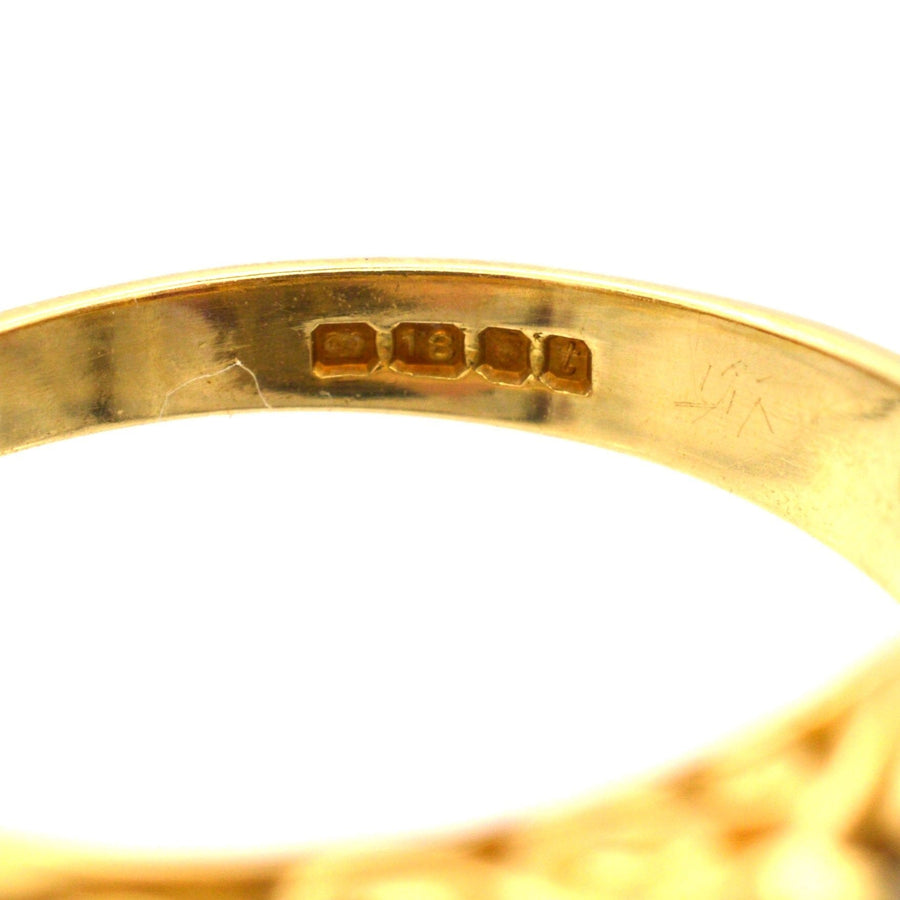 Close-up of the hallmark on a Victorian-style 1970s 18ct gold hoop ring.